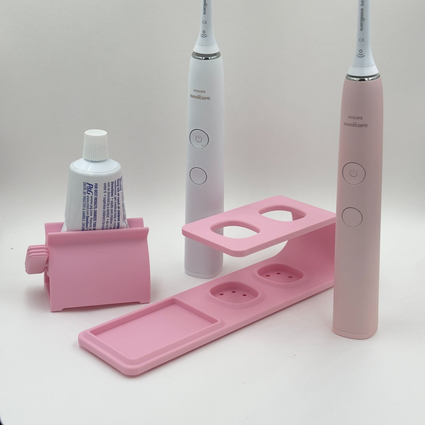 Suport pentru doua periute Philips Sonicare Roz cu dispozitiv de stoarcere a pastei de dinti