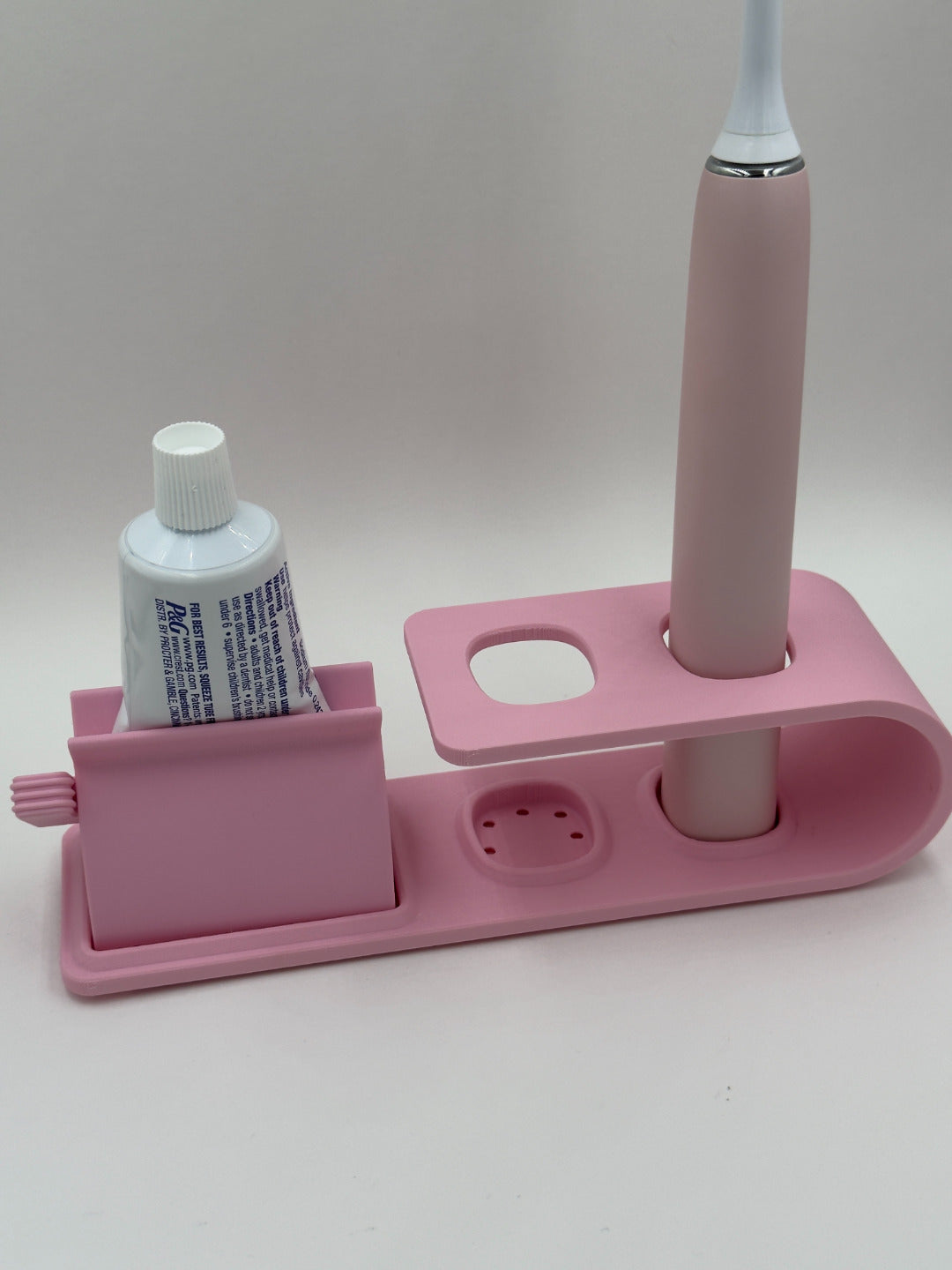 Suport pentru doua periute Philips Sonicare Roz cu dispozitiv de stoarcere a pastei de dinti